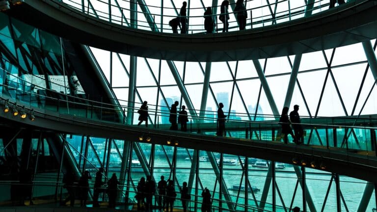 Abstract modern architecture and silhouettes of people on spiral staircase