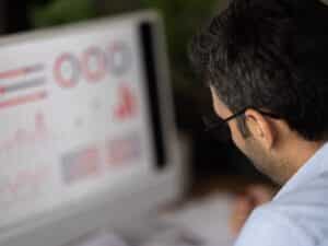 Young finance market analyst in eyeglasses working