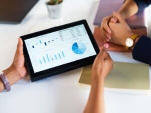 Hands, business people and tablet chart for data analysis, infographic review or dashboard logistics. Digital technology, analytics graphs and meeting to research internet statistics, growth or stats
