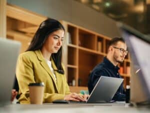 Group,Of,Diverse,Creative,Team,Members,Using,Laptops,In,An