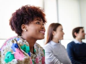 Smiling young businesswoman in a boardroom meeting