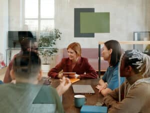Board meeting around table with devices