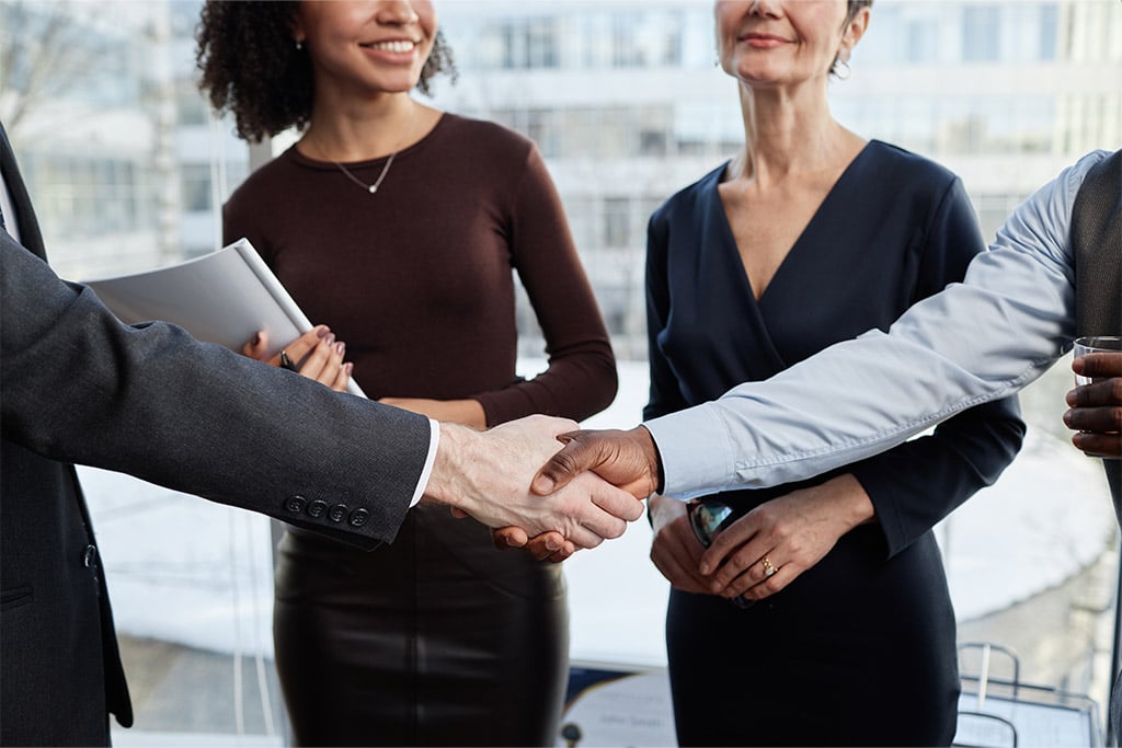Close up of group hand shake