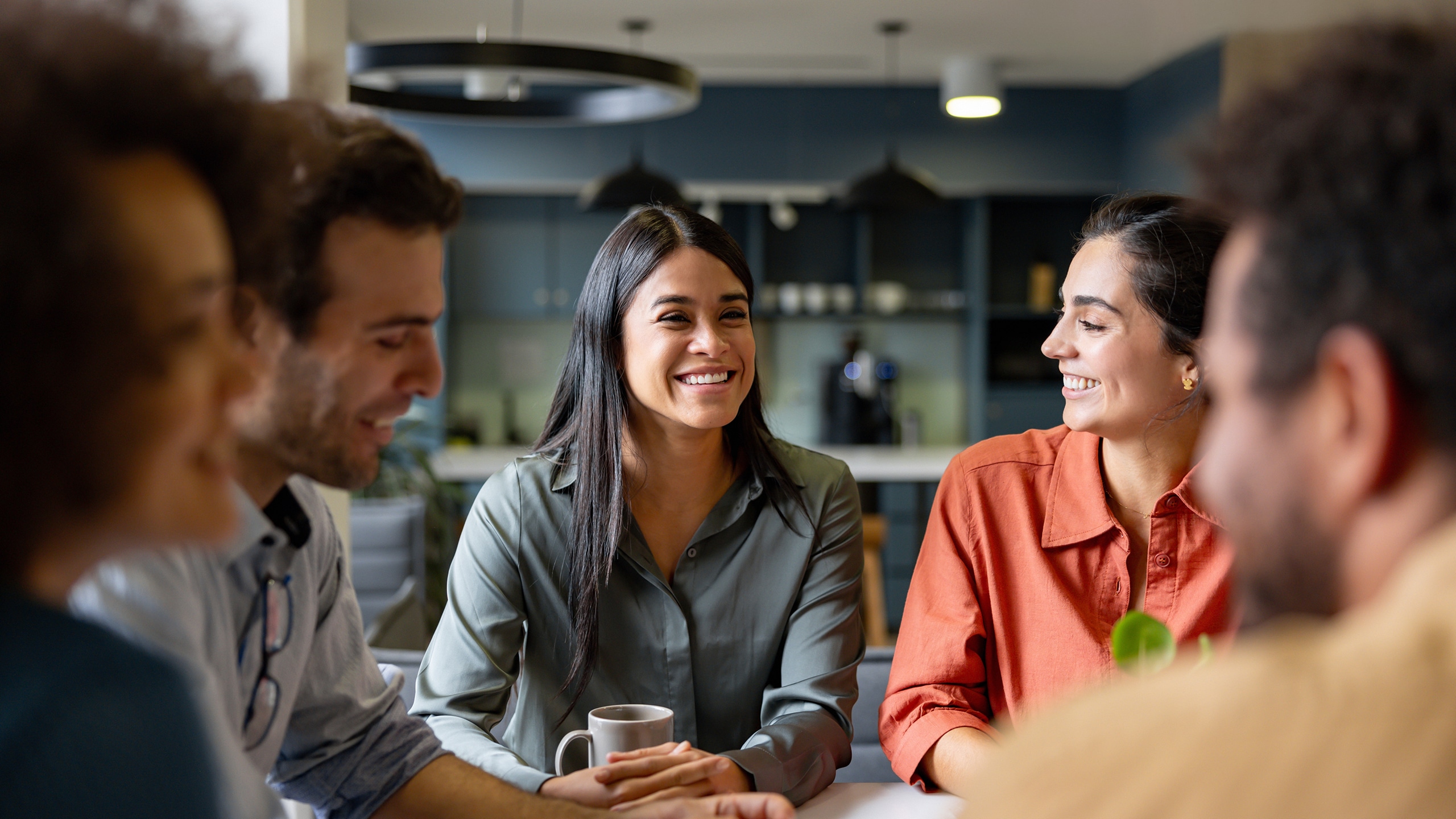 Happy Latin businesswoman smiling in a meeting at the office