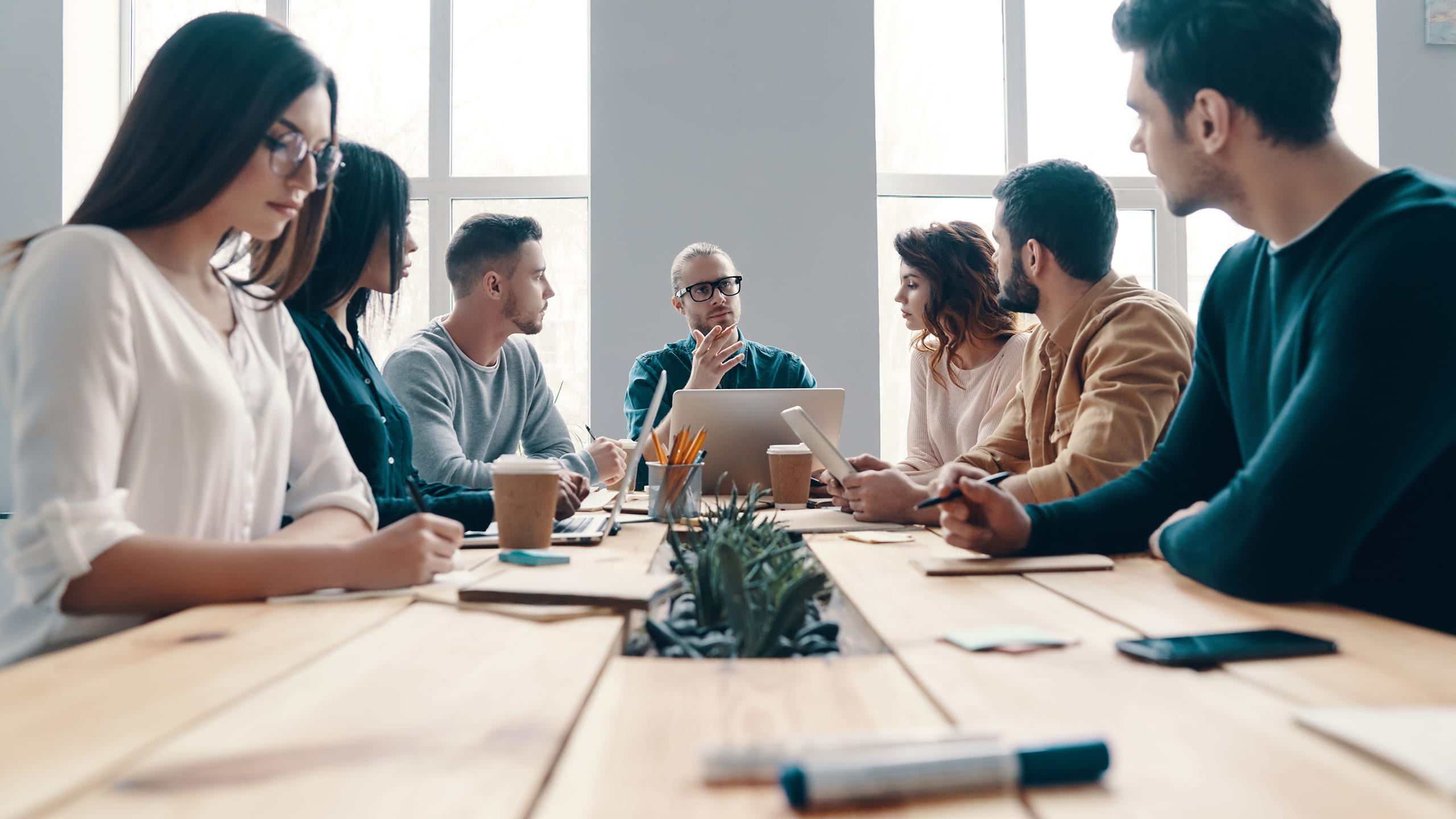 Leader leading group discussion around table
