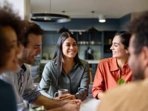 Happy Latin businesswoman smiling in a meeting at the office