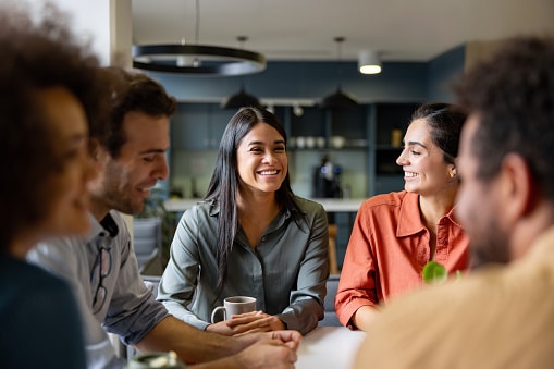 Happy Latin businesswoman smiling in a meeting at the office